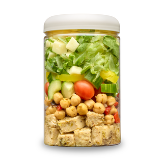 Italian Chopped Salad cup layered with roasted herb chicken, chickpeas, grape tomatoes, cucumber, banana peppers, provolone and gardengreens.