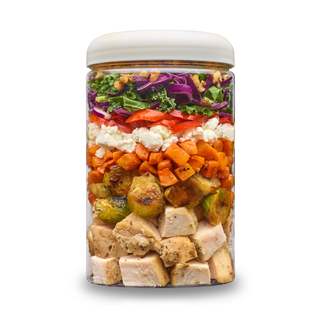 Roasted Chicken + Hot Maple Brussels cup layered with roasted chicken, hot maple Brussels sprouts, roasted carrots, goat cheese, red cabbage and kale.