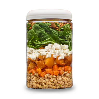 Roasted Veggies + Farro cup layered with farro pilaf, roasted carrots, butternut squash, goat cheese, spinach, arugula and toasted seeds.