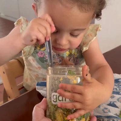 A child eating from a GardenCup™ salad jar, highlighting fresh, family-friendly meals that make healthy eating fun and effortless.
